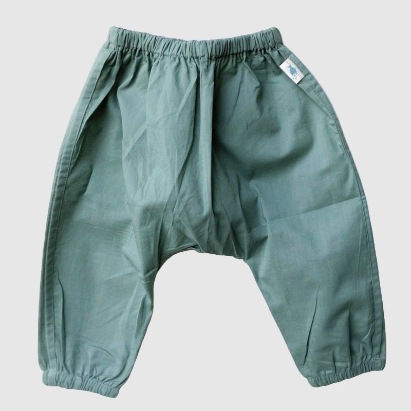 organic cotton Green pants on a textured white surface for kids to wear