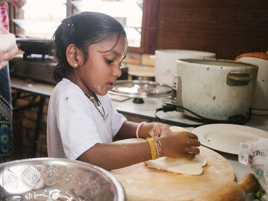child making pancakes for the family