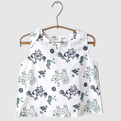 organic cotton white sleeveless top with blue and green cat pattern on a wooden hanger against a white background for kids to wear during summer