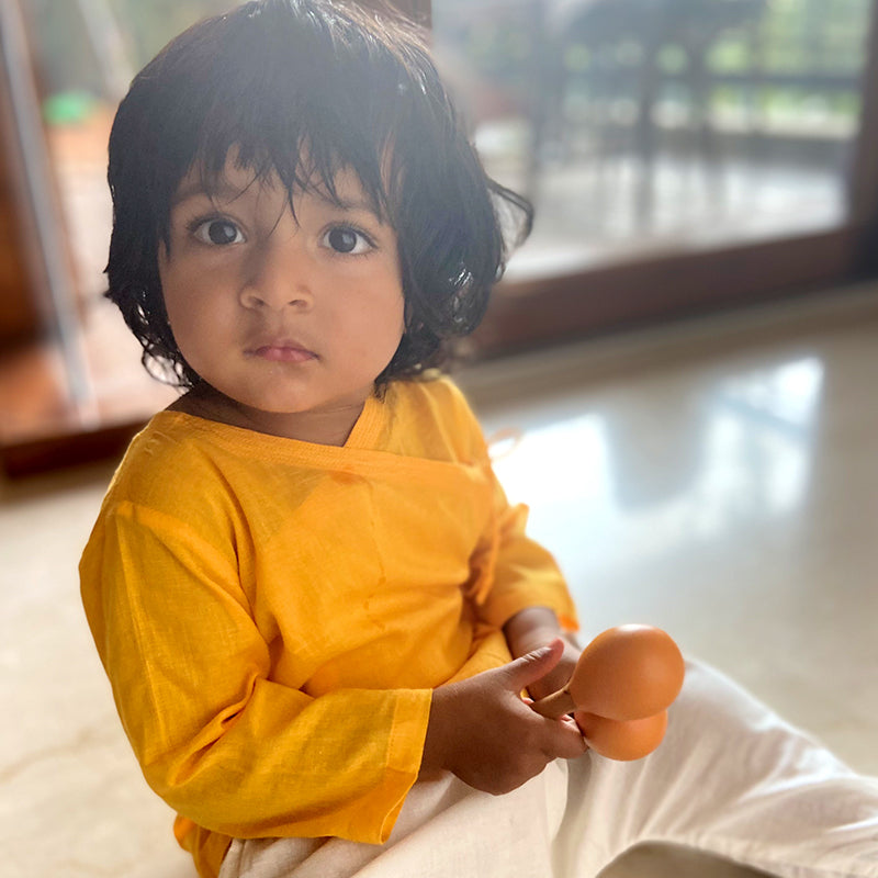 Eczema-friendly baby clothing set with traditional story-themed prints, made from eco-friendly organic cotton
